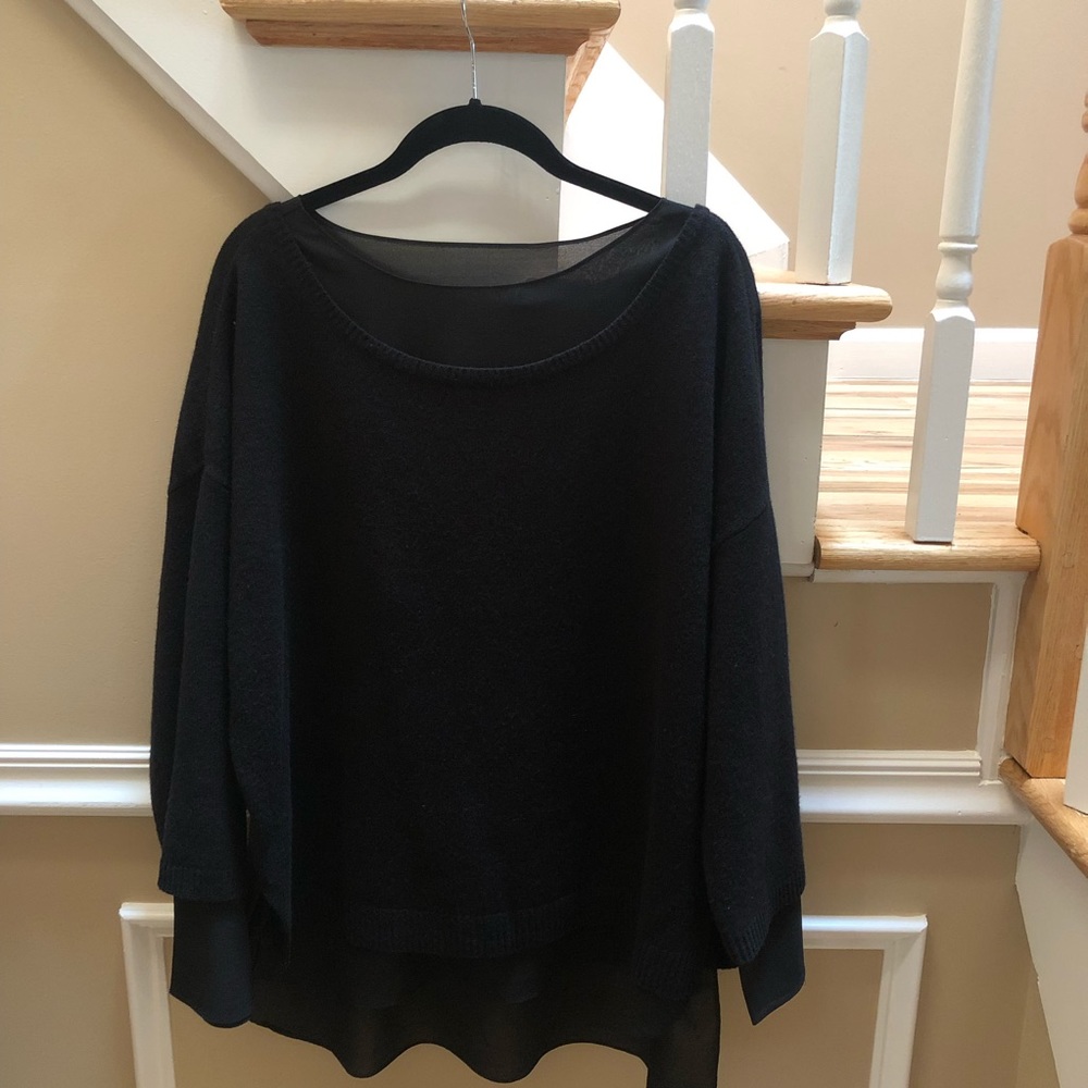 Black wool sweater with sheer black underlay.